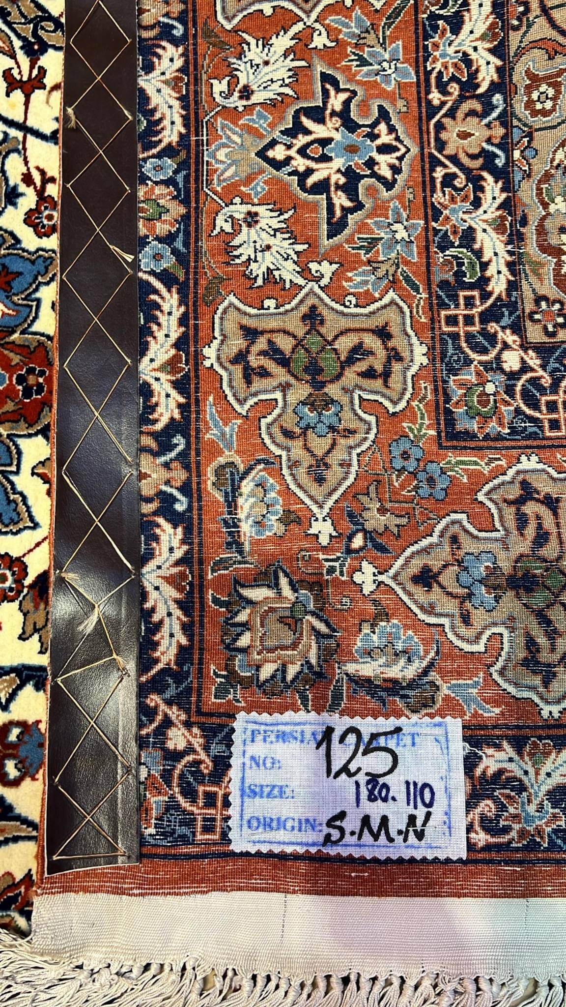 "Backside view of a hand-knotted Seirafian rug, highlighting the fine knotting and silk warp for durability."